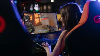 A woman plays a shooter video game on PC (stock image)