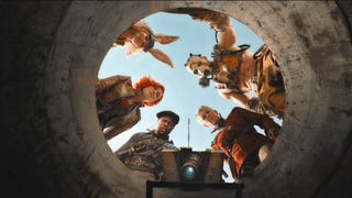 An image from the Borderlands movie looking up at its cast - including Cate Blanchett and Jack Black as Claptrap - as they stare down a large pipe.