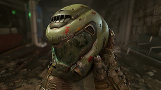 A Doom Eternal screenshot showing Doomguy holding up his iconic green helmet and viewing it in first-person.